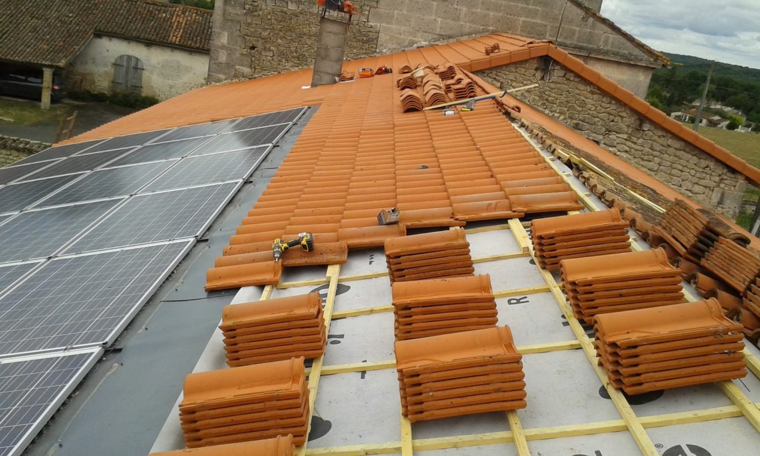 Rénovation de toiture avec panneaux solaires et tuiles