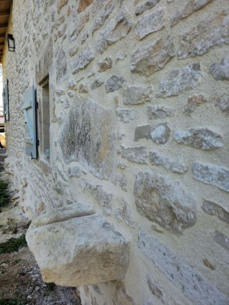 Joints à la chaux sur un mur en pierre rénové à Terres-de-Haute-Charente